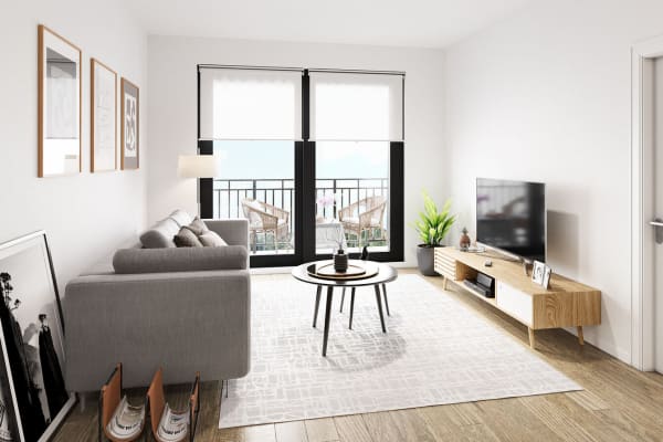 Furnished living room with sliding door to private balcony at Shalimar at Plantation in Plantation, Florida