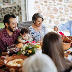 Family dinner on the patio of a home at Vista Park in Dallas, Texas