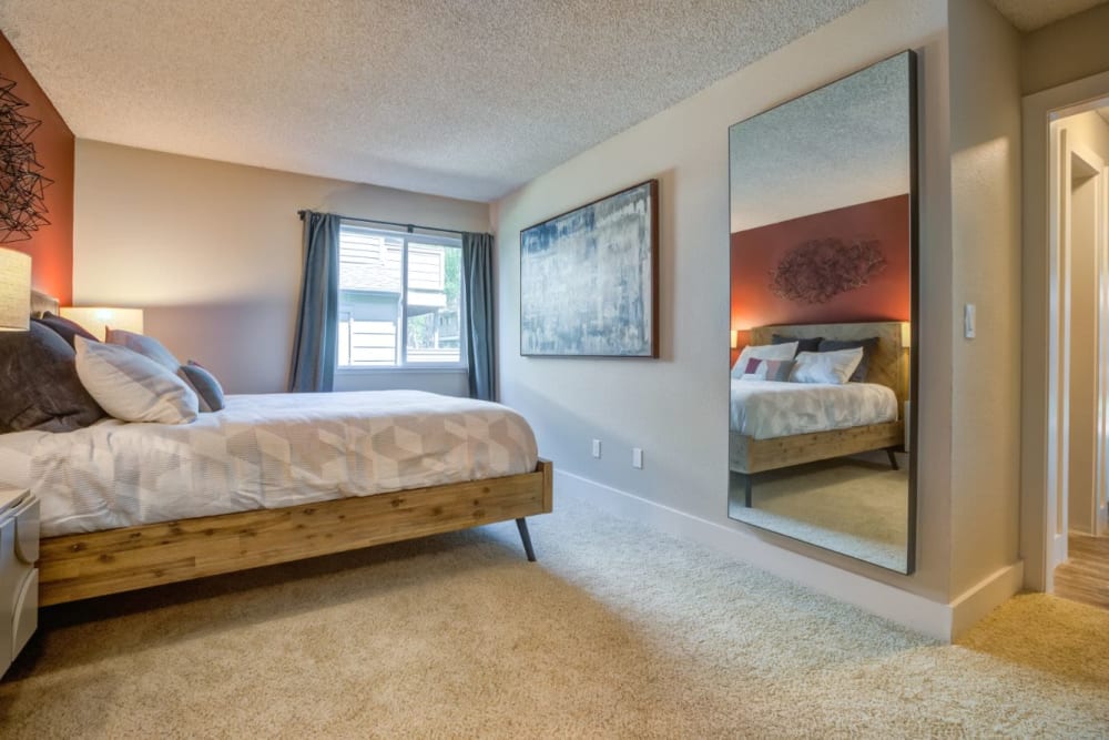 Plush carpeting and a draped window in a model home's bedroom at Sofi Union City in Union City, California