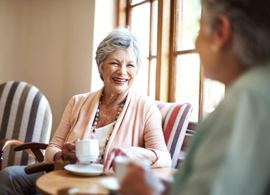 Senior woman laughing with friend at Clearwater at South Bay in Torrance, California