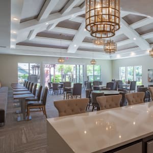 Room filled with tables and chairs at Sunstone Village in Denton, Texas