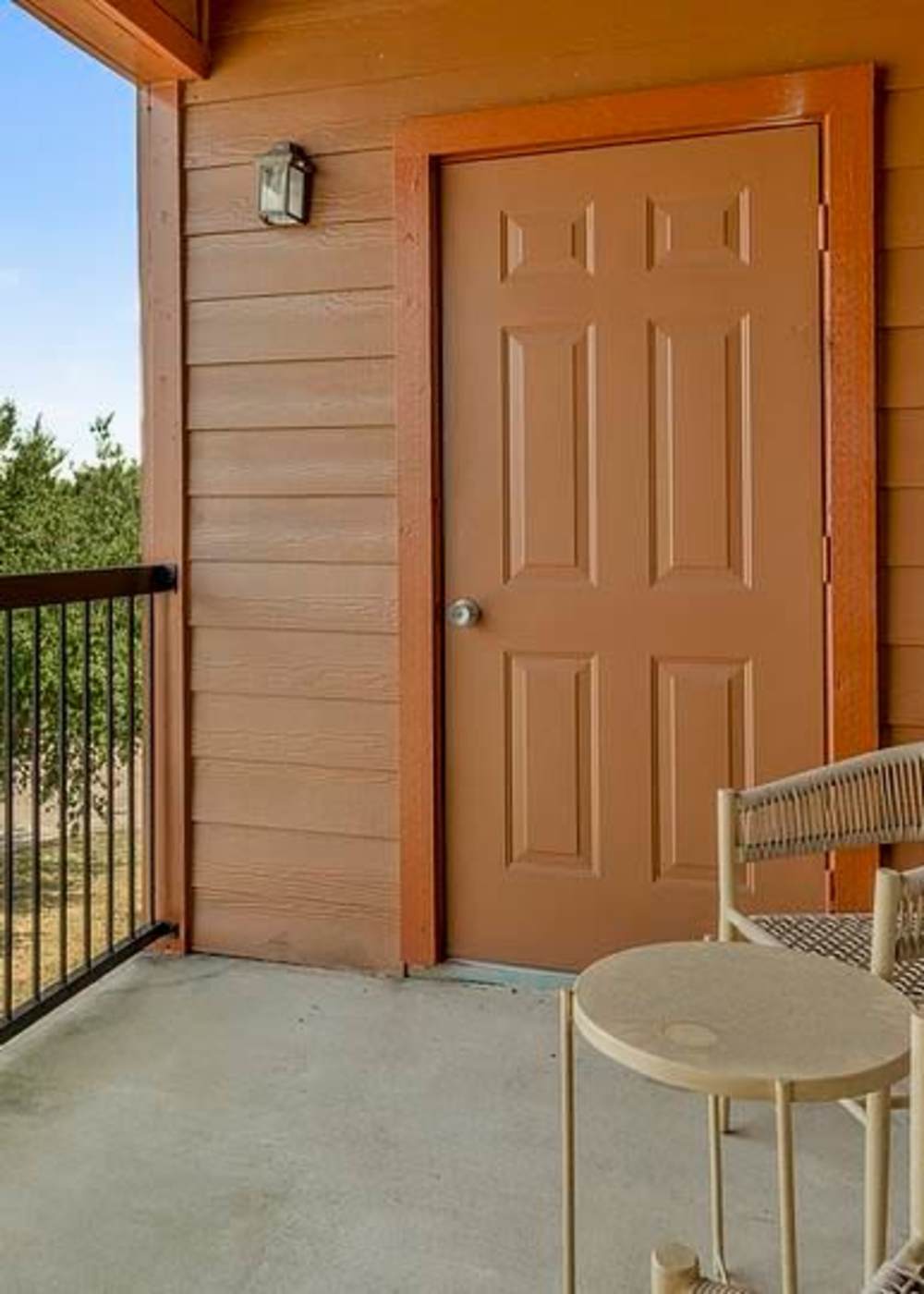 Private balcony with chairs at Settlers Ranch Apartments in Houston, Texas