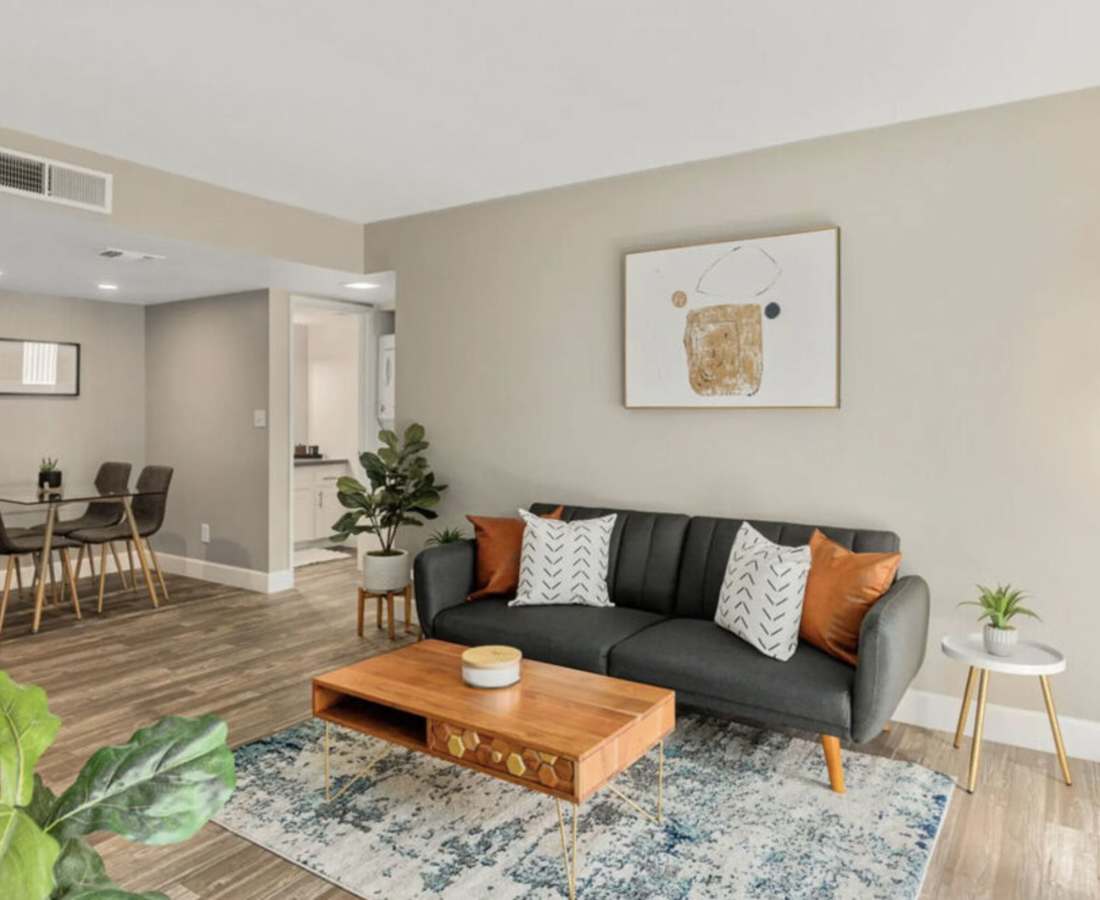 Spacious living room with coffee table, couch and more at Raystone Apartments in Phoenix, Arizona