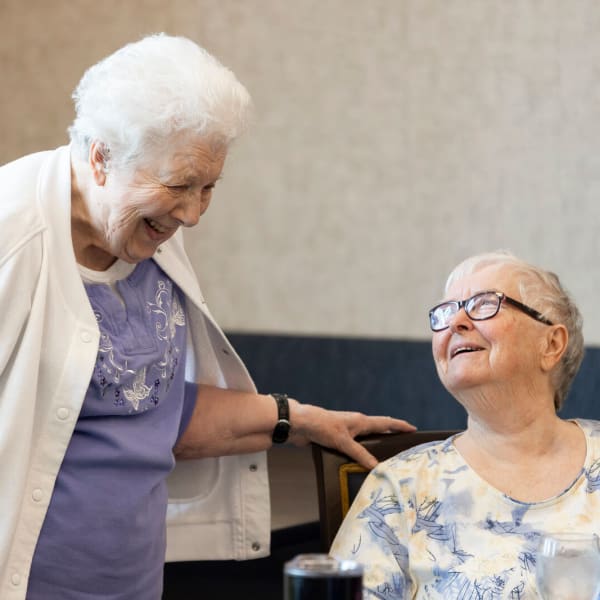 Two residents smiling together at The Westbury Senior Living in Columbia, Missouri
