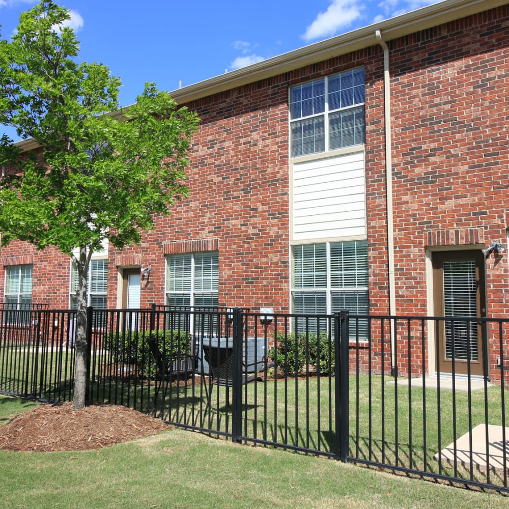 Gated yards outside townhomes at Oaks Estates of Coppell in Coppell, Texas