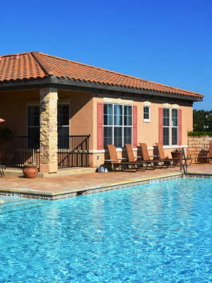 Pool area with lounge seating at  The Abbey at Stone Oak