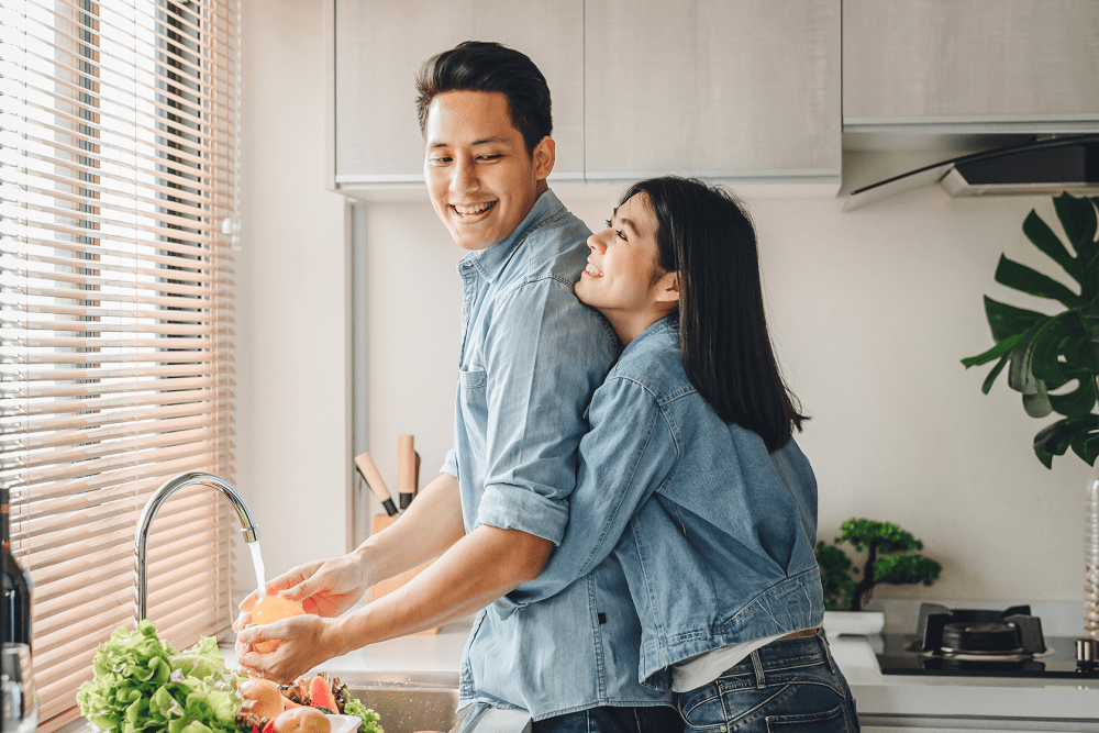 Couple cooking together in their full-equipped modern kitchen at Stoneridge at Mark Center Apartment Homes in Alexandria, Virginia