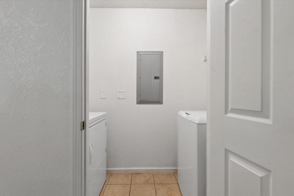 Charming laundry space with ample natural light at Covington Woods Apartments in Lansing, Kansas.