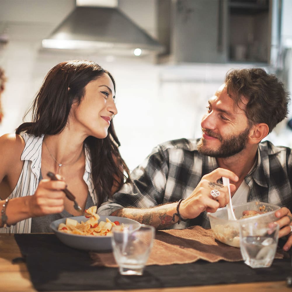 Rendering residents having dinner on their kitchen at Bellerose at Bees Ferry in Charleston, South Carolina