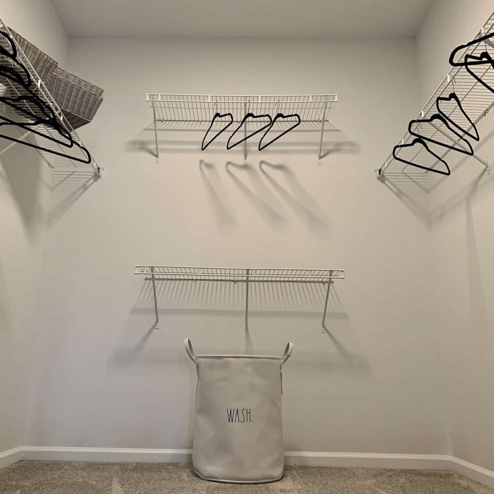 Closet with laundry bad and hangers at Preserve At Columbus Park in Columbus, Georgia