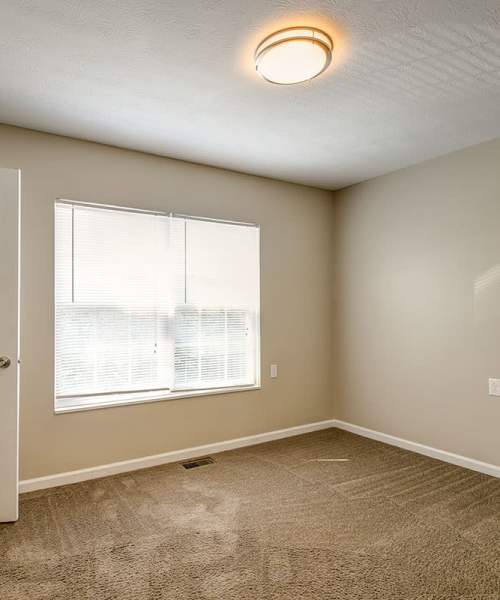 Beautiful bedroom with carpet flooring and ceiling lights at Hyden Greene in Philippi, West Virginia
