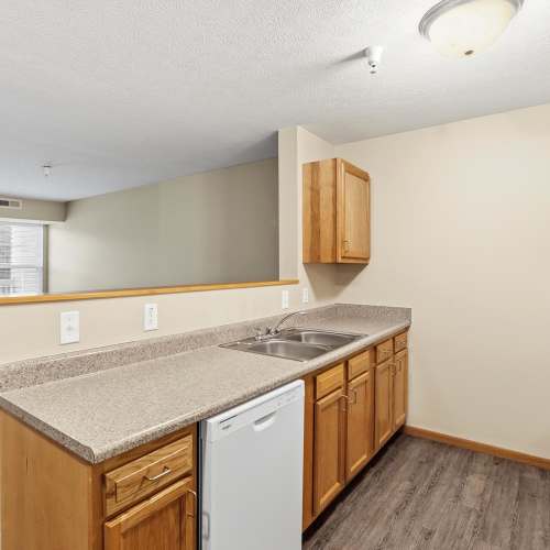A kitchen with a white colored dishwasher at Norwood Greene Senior Living in Marietta, Ohio