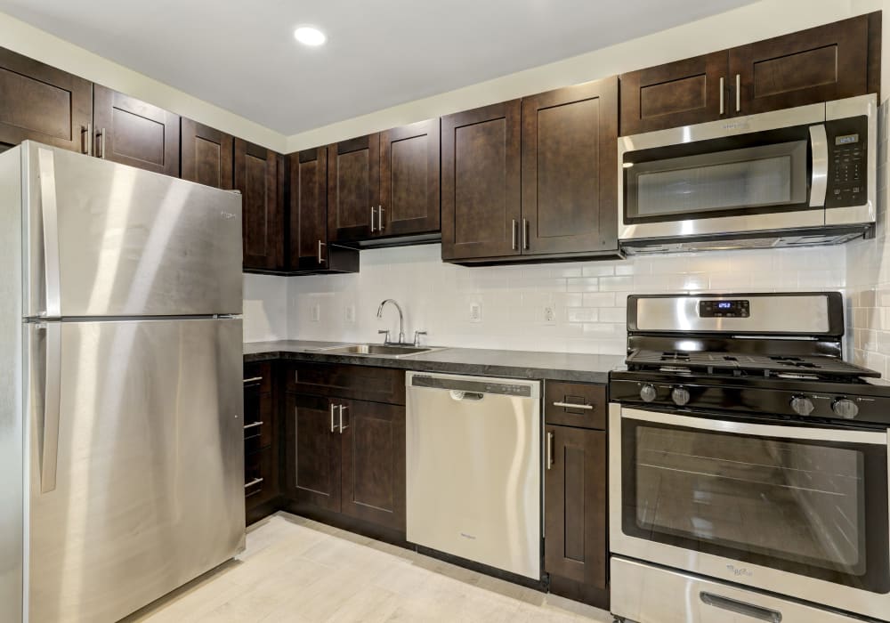 Kitchen with off dark cabinets and stainless steel appliances at Wynbrook West Apartments in East Windsor, New Jersey