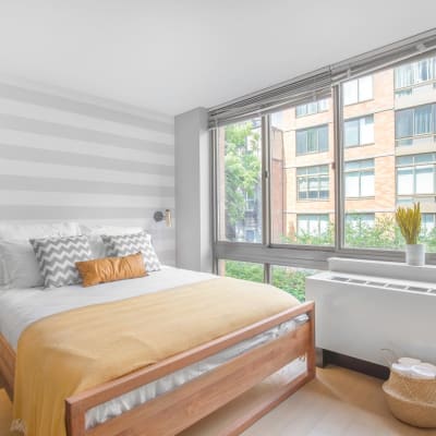 Bedroom with huge windows at The Sierra Chelsea in New York, New York