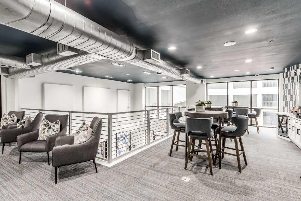 A community dining space with comfy seating at Briar Forest Lofts in Houston, Texas