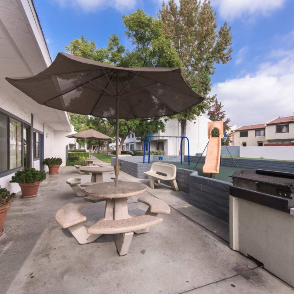 Community outdoor seating at Apartment flag at Fairvalley Villa in Covina, California