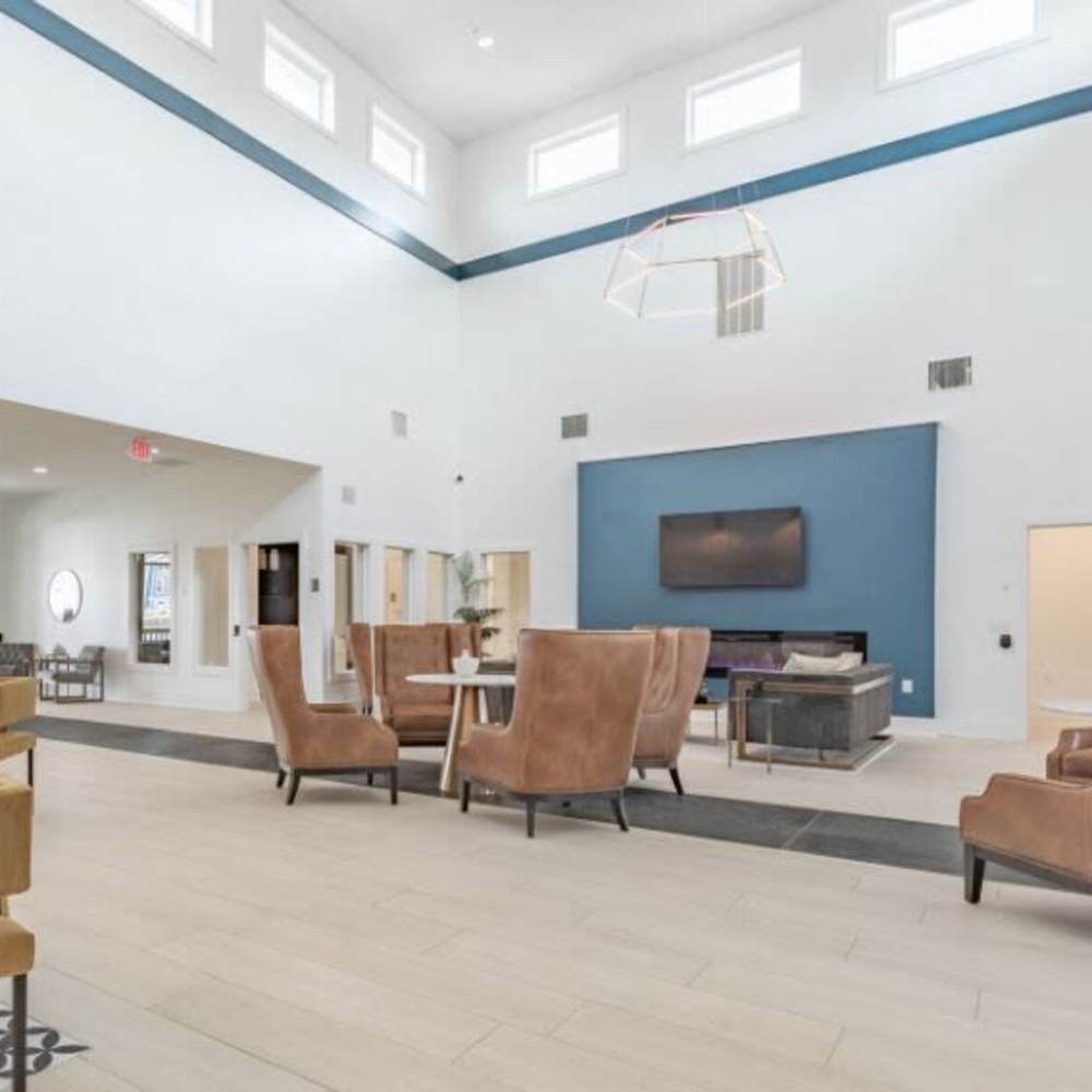 Spacious lounge with modern seating arrangements at The Apartments At Kelton Station in Williamsburg, Virginia