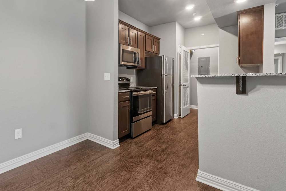 Well-equipped kitchen with wood style flooring at Pine Creek in Paris, Texas