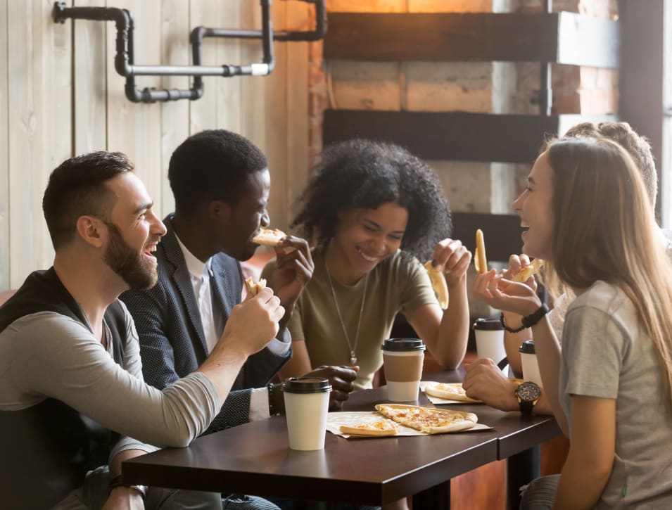 Resident friends enjoying a snack with their coffee at their favorite café near Verse Seattle in Seattle, Washington