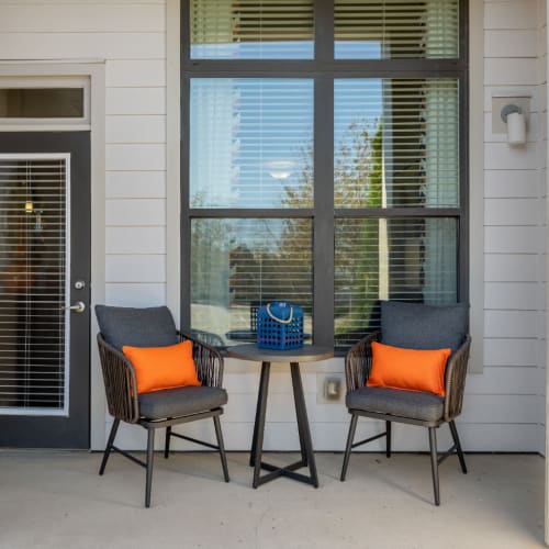 Private balcony with chairs and side table at Marq at Crabtree in Raleigh, North Carolina