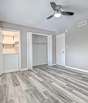 Unfurnished bedroom with closet, plank flooring and air condition desk at Woodside Village in Valparaiso, Indiana