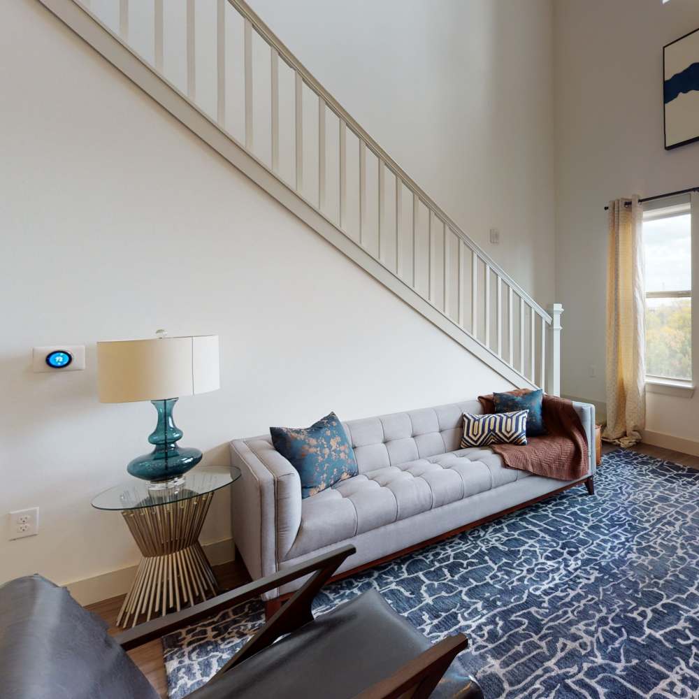 Living room leading stairs to bedroom at Howell Uptown in Dallas,Texas