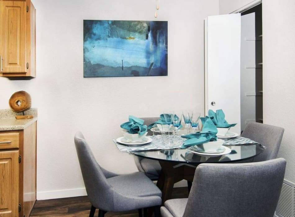 Cozy dining area with seats for four in a model home at Sofi Belmar in Lakewood, Colorado