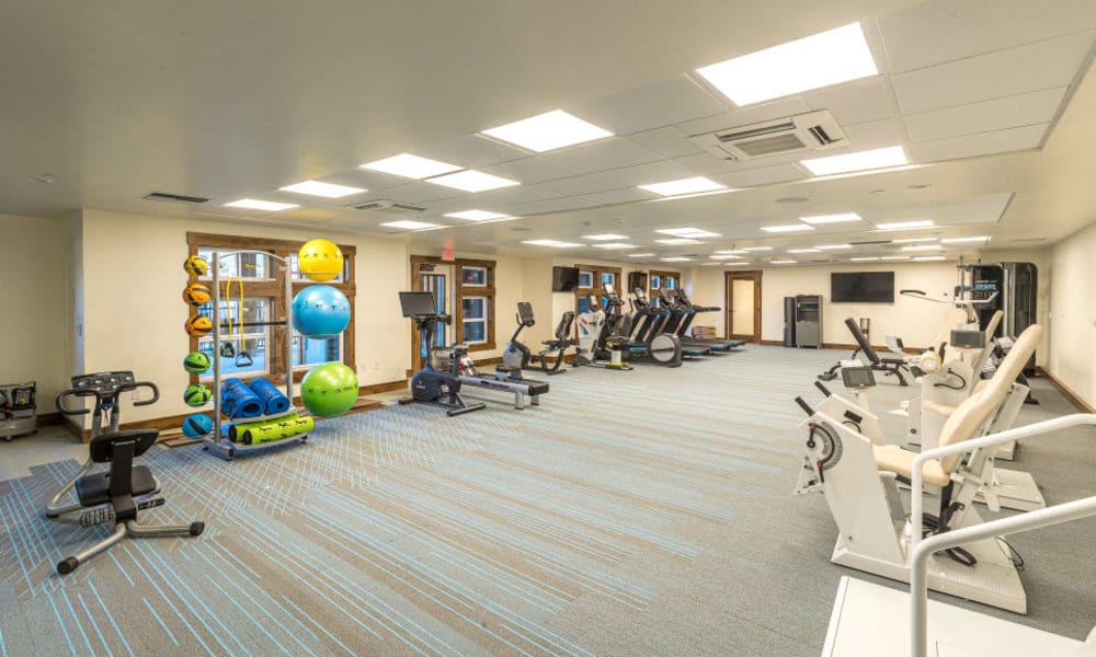 Exercise room with various workout equipment at Touchmark at Pilot Butte in Bend, Oregon