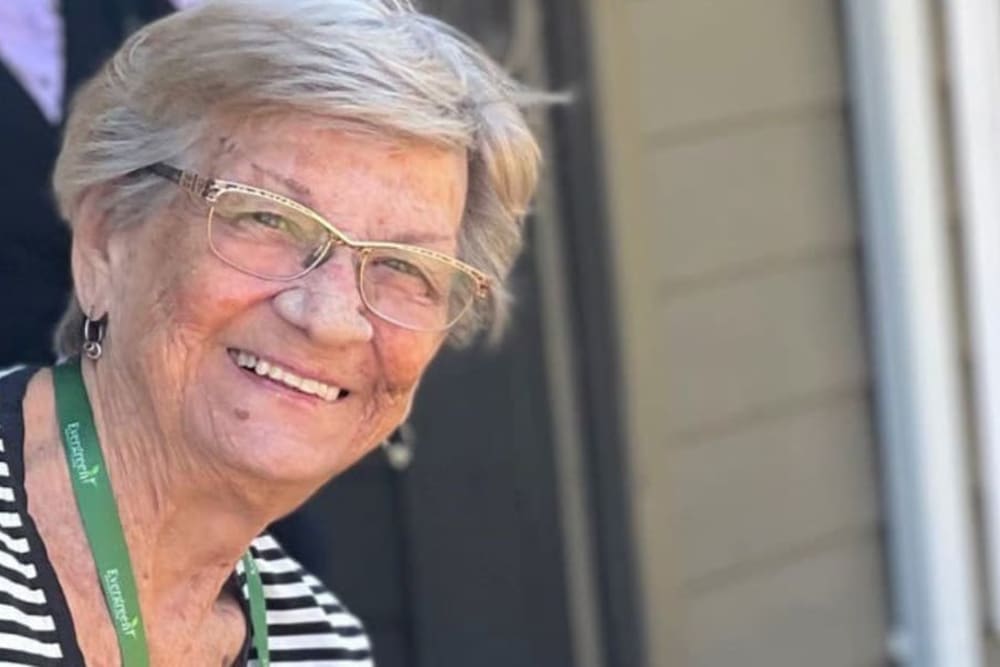 A smiling resident at Evergreen Memory Care in Eugene, Oregon.