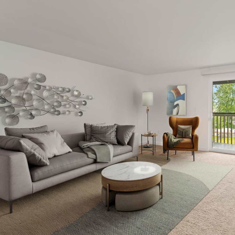 Spacious living room with sliding door access to a private balcony at Bluffs at Evergreen in Everett, Washington