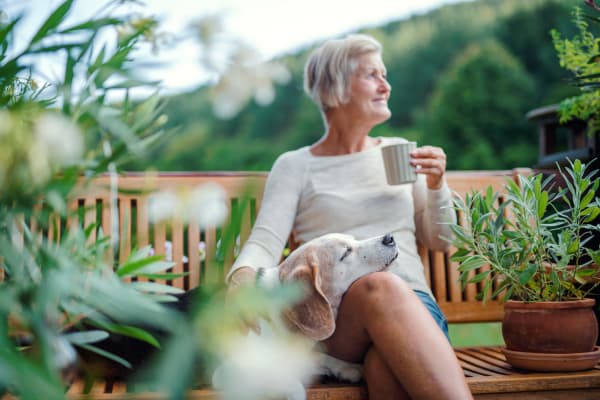 A women drinks coffee with her dog at First & Main of New Albany in New Albany, Ohio