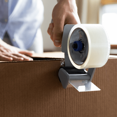 Sealing a box with packing tape at A-American Self Storage in Ridgecrest, California