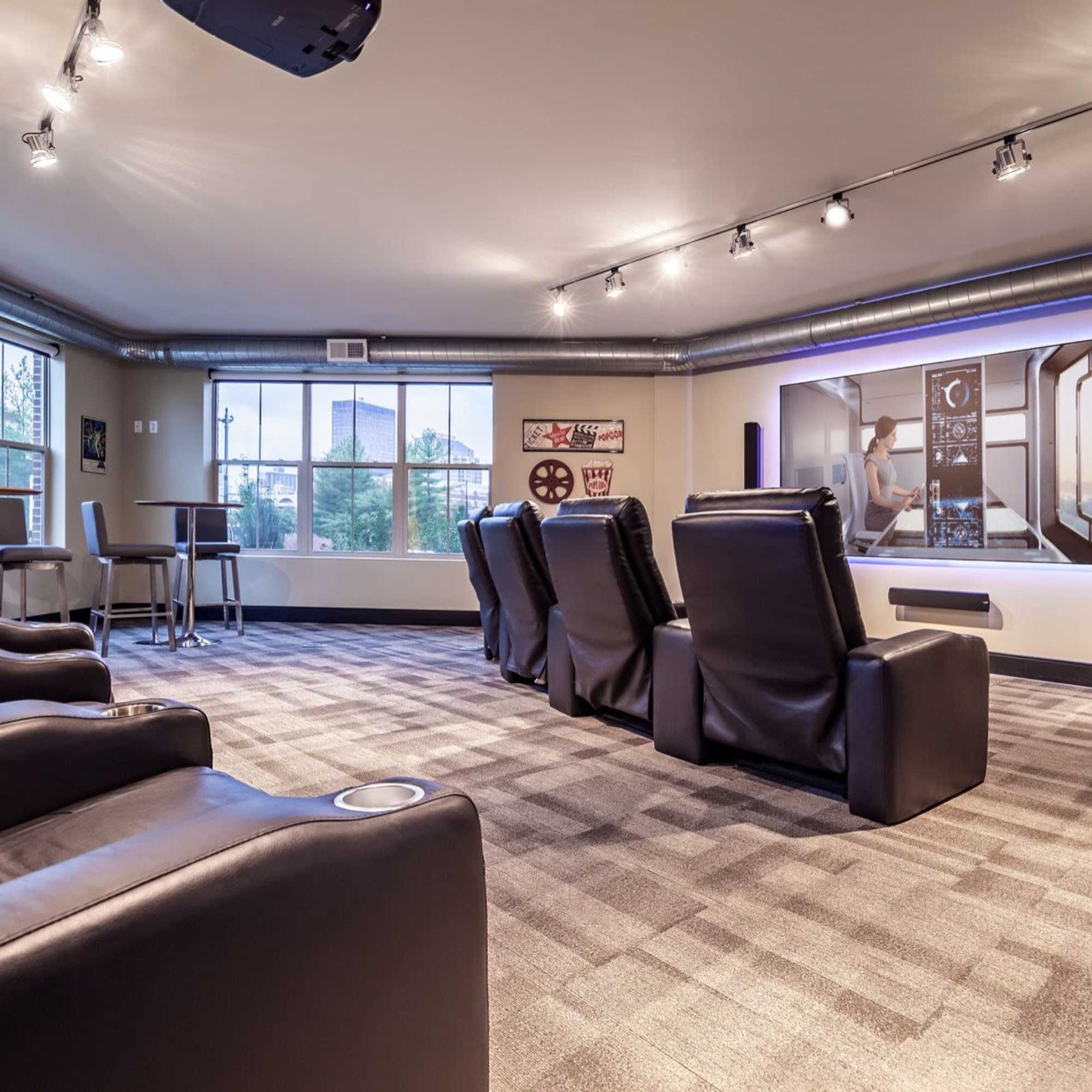 Cozy media room with plush seating, large screen, and modern decor, perfect for movie nights at Water Street Apartments in Dayton, Ohio