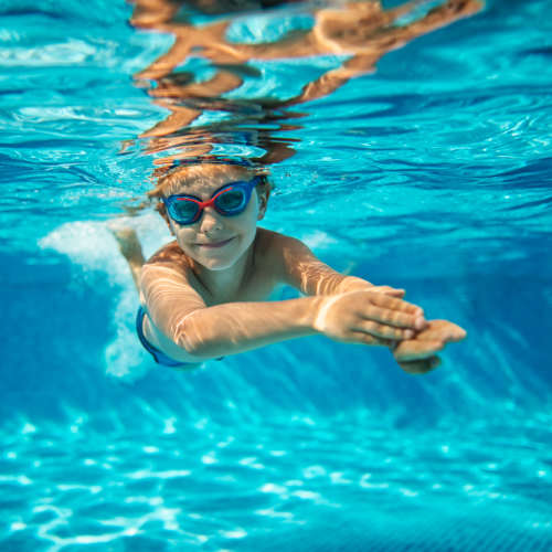 A kid enjoying in swimming pool at Paddock Club Apartments in Florence, Kentucky