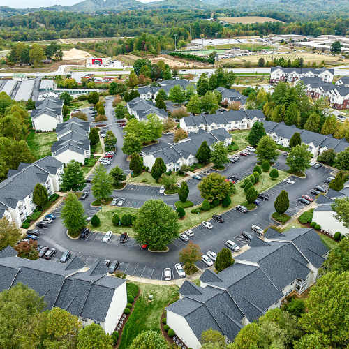 Drone view of apartment buildings and grounds at Brittany Place Hendersonville in Henderson, North Carolina