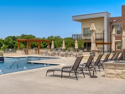 lounge area with chairs near the pool at The Gates at Meadow Place in Willow Park, Texas