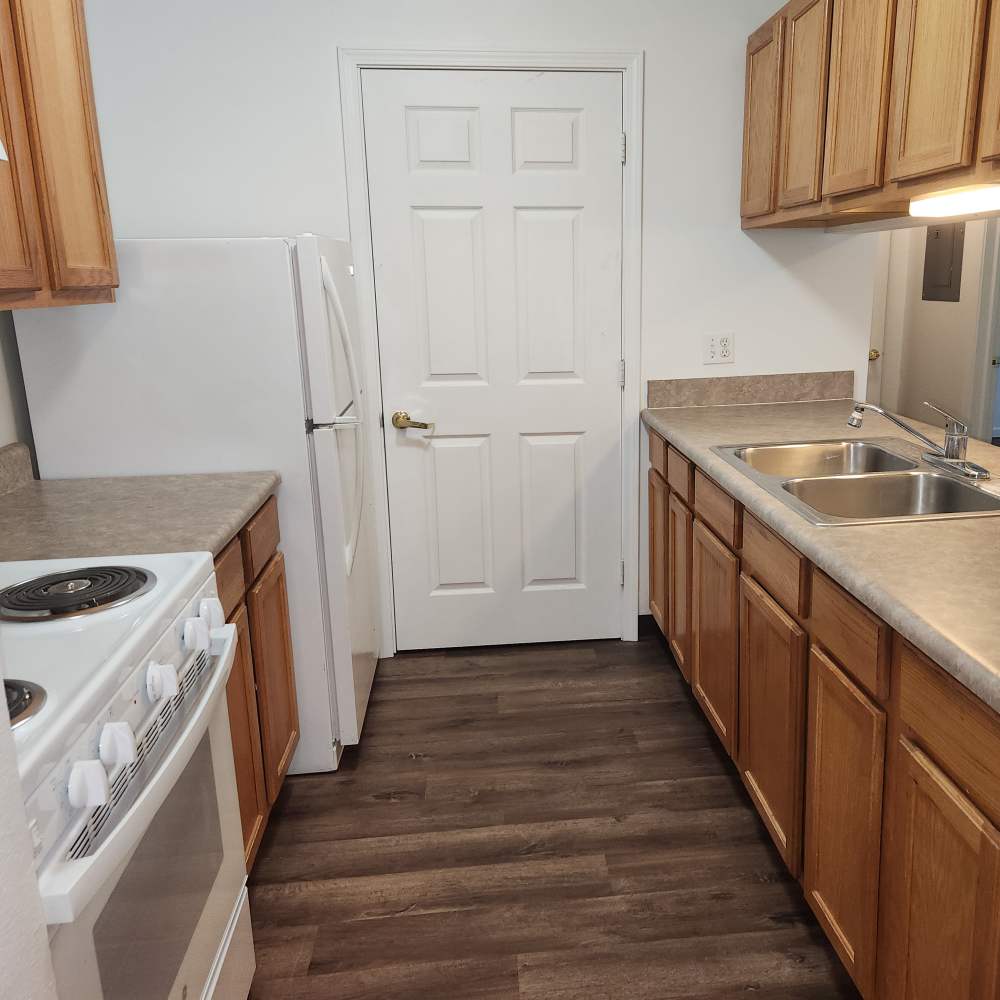 Apartment kitchen with energy efficient appliances at Woodbrook Apartments in Three Rivers, Michigan