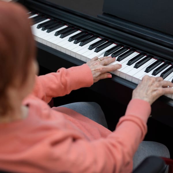 Resident playing the piano at The Westbury Senior Living in Columbia, Missouri