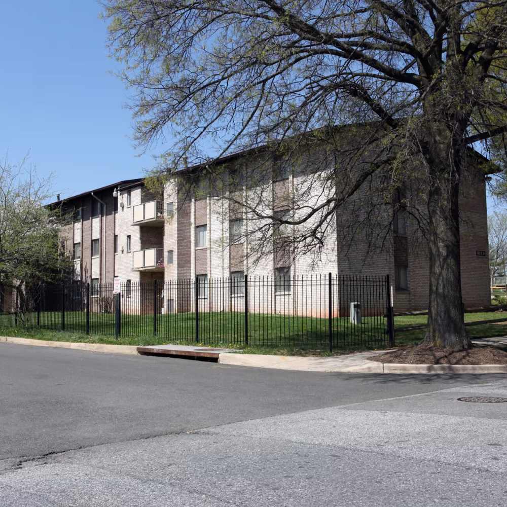 Charming exterior view of the apartment building with paths leading towards the apartment homes at Glenreed Apartments in Glenarden, Maryland