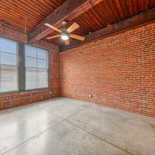 Unfurnished bedroom with ceiling fan at Stadium Loft Apartments in Saint Louis, Missouri