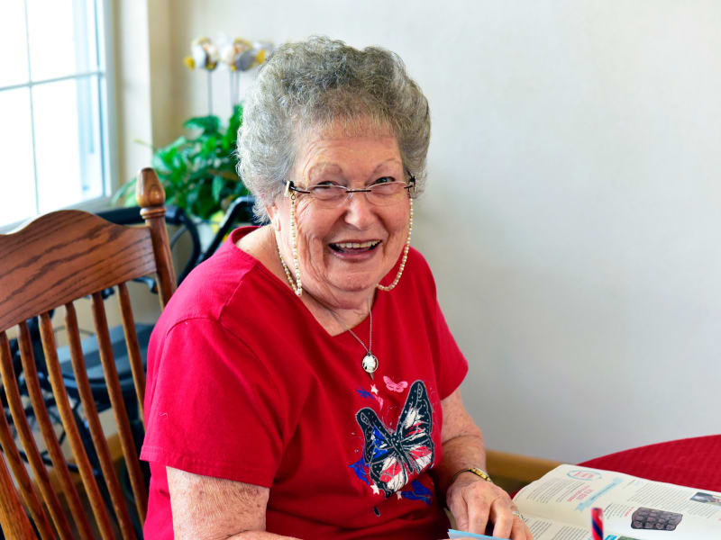 Resident smiling in shared common space at Garden Place Millstadt in Millstadt, Illinois