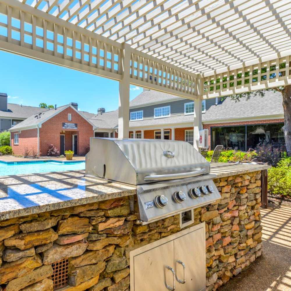 Outdoor barbecue station beside the pool at Madison at Schilling Farms in Collierville, Tennessee