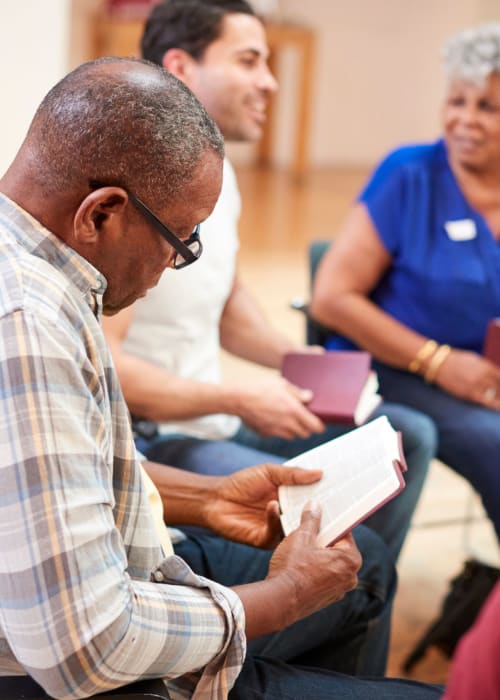 Group of residents reading books together at Liberty Arms Assisted Living in Youngstown, Ohio