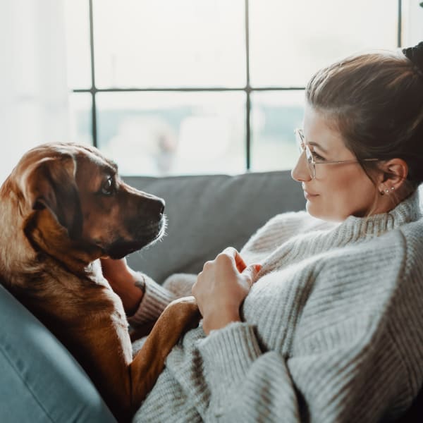 A resident enjoying time with her dog at Attain at Quarterpath, Williamsburg, Virginia