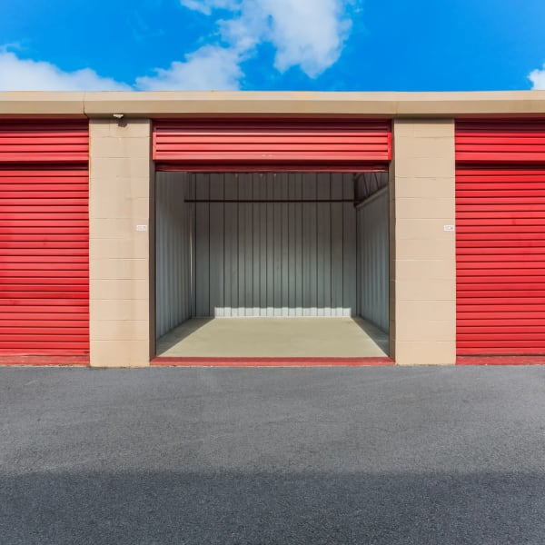 Outdoor storage units with red doors at StorQuest Self Storage in Tampa, Florida