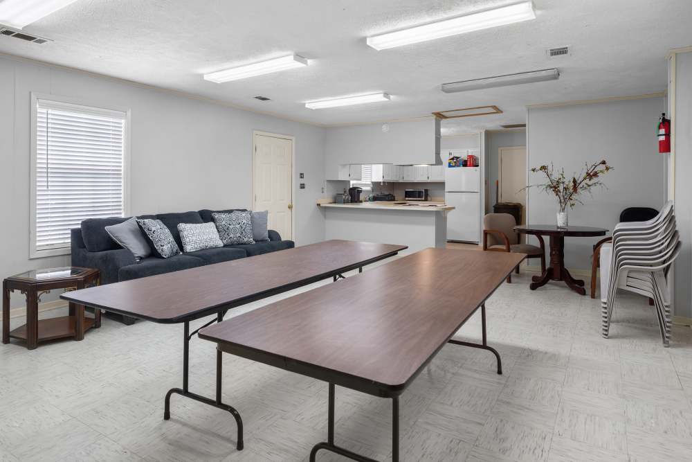Bright and inviting open space with a cozy couch and modern kitchen area at Pecan Ridge in Vicksburg, Mississippi.