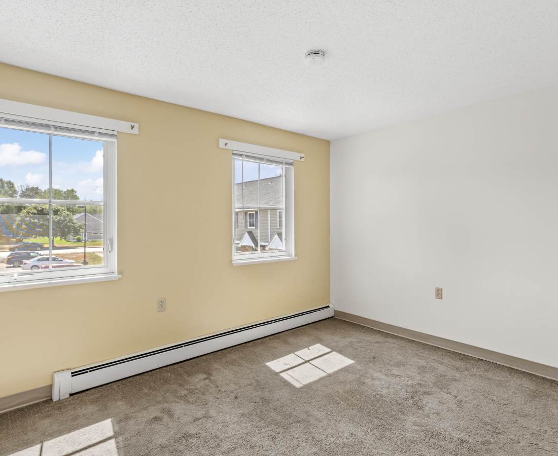 Bedroom with windows and sunlight at Glenridge Gardens in Augusta, Maine