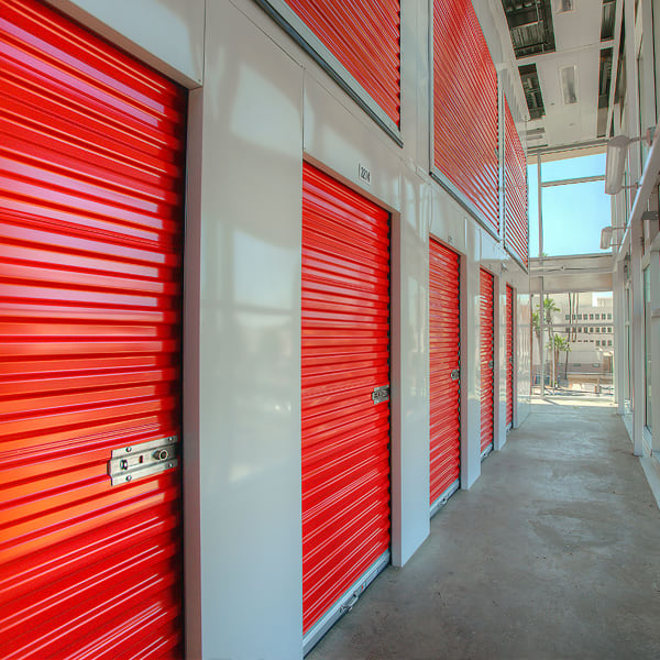 Indoor storage units with bright doors at StorQuest Self Storage in Golf, Florida