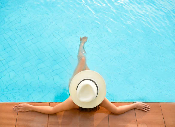 Resident relaxing in the swimming pool at The Parks on Village in Bossier City, LA