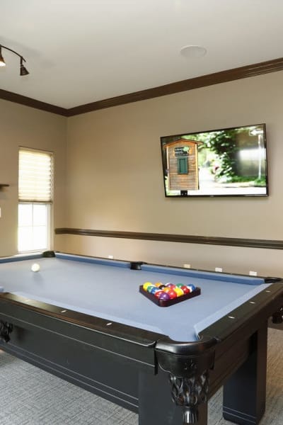 Billiard table with pool sticks at Waterford Place in Greenville, North Carolina